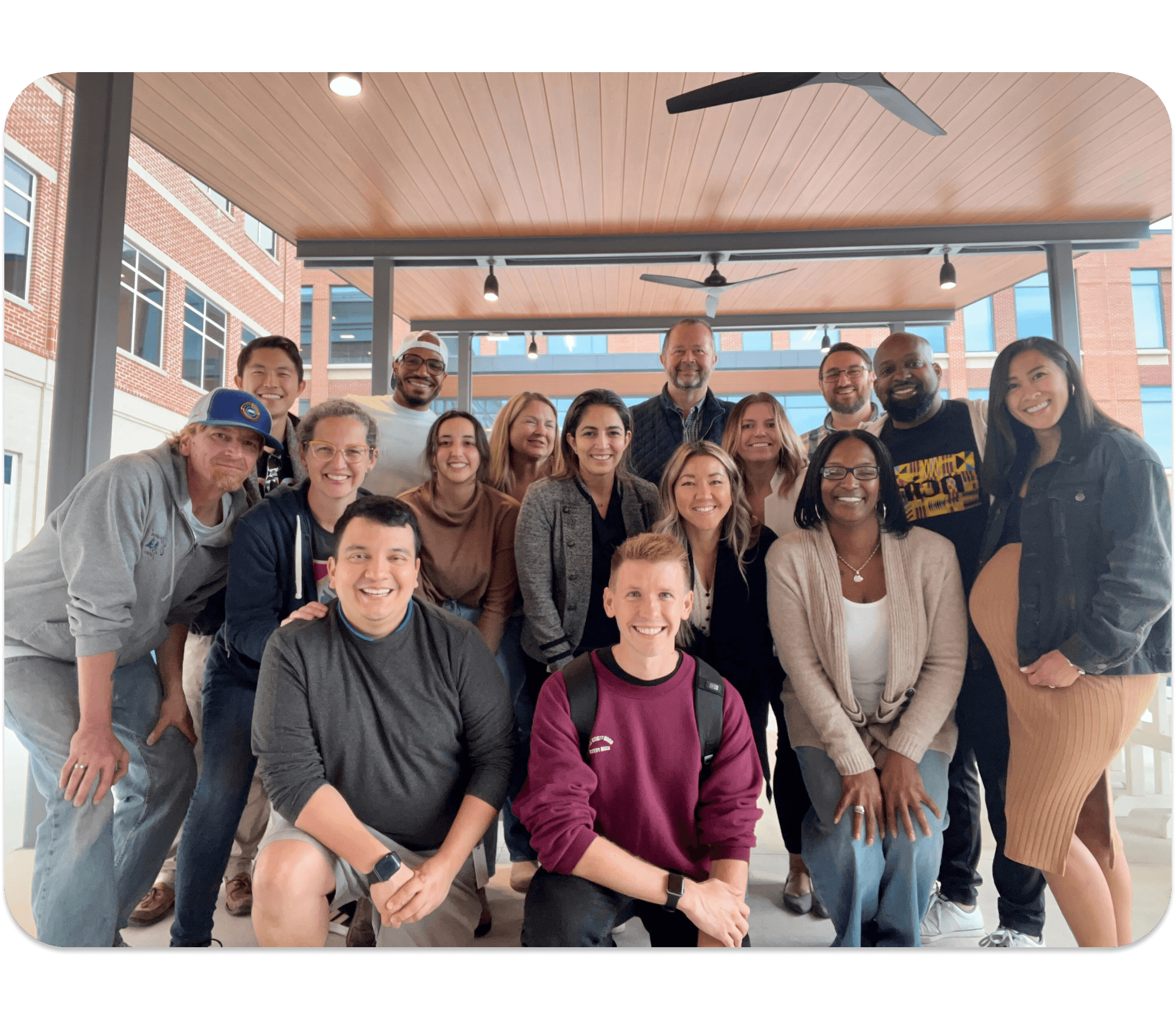 A group of nCino leaders for the diversity, equity, and inclusion council smile at the camera under a covered patio outside.