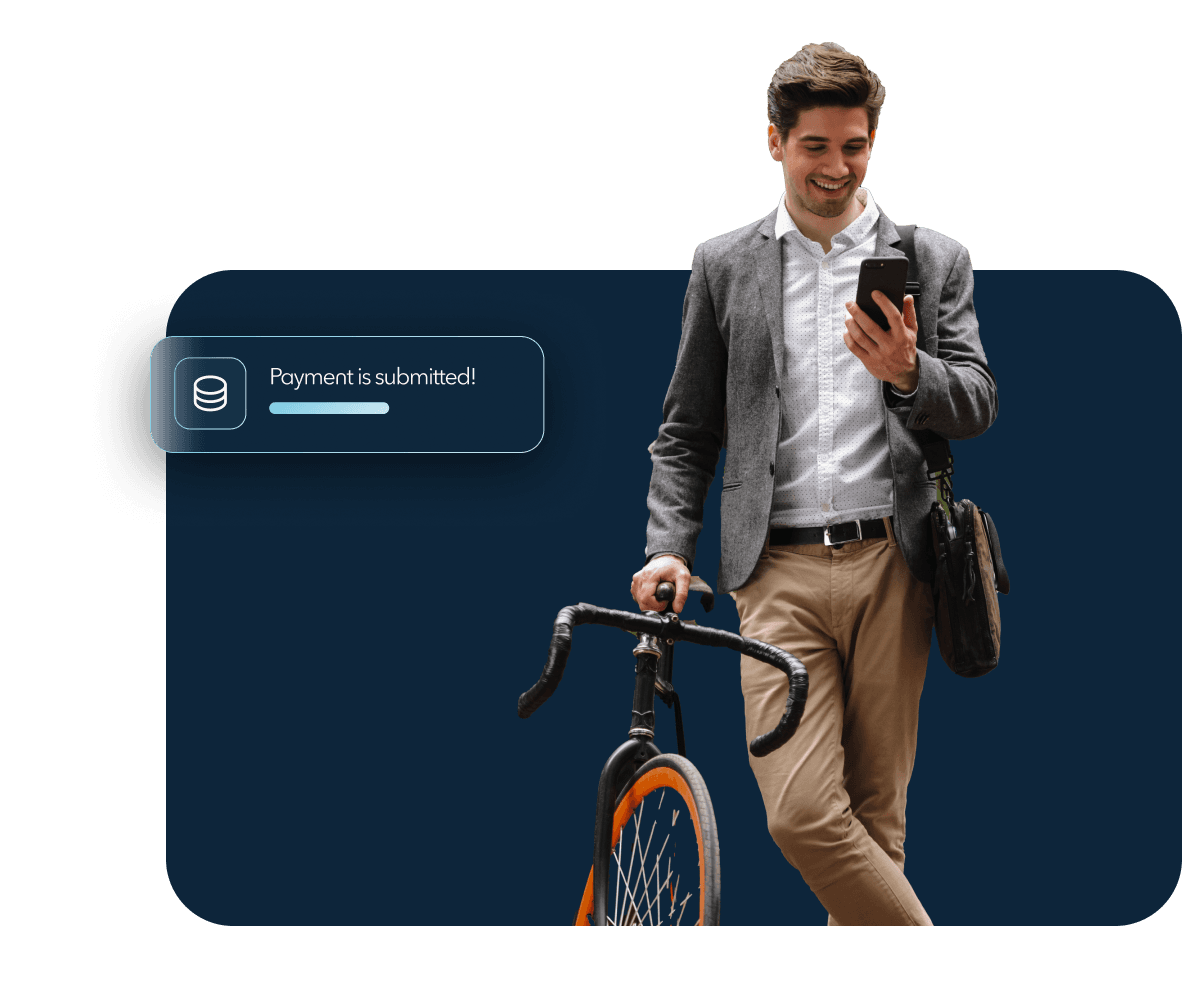 A man standing with his bicycle looking at his phone